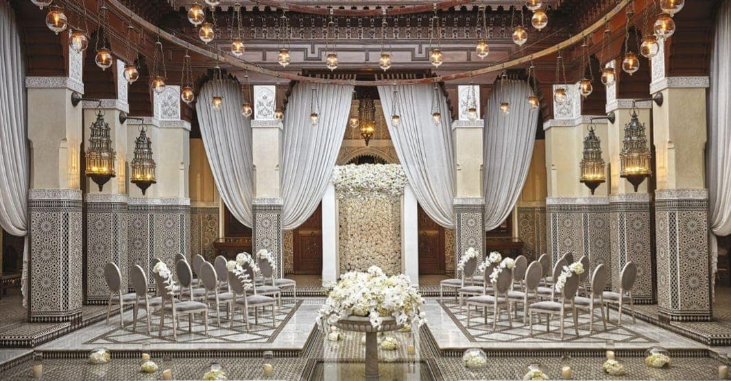 Ceremony in a Moroccan palace with zellige mosaics and white drapes